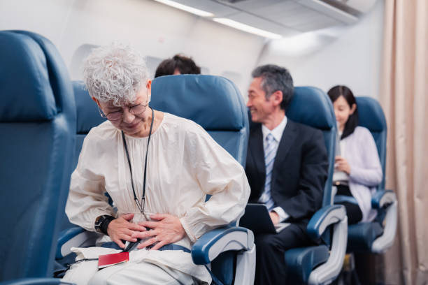 istock Elderly Woman Suffering from Illness on Airplane 1449816338