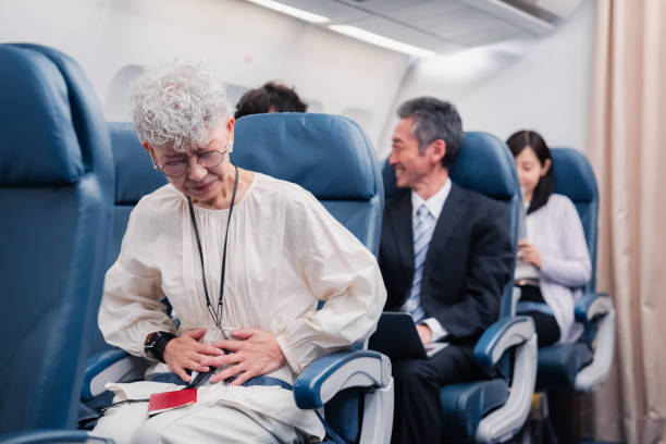 istock Elderly Woman Suffering from Illness on Airplane 1449816341