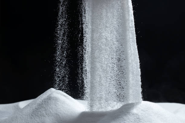 istock White quartz sand pours on a black background 1449816348