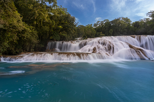 Rochester Falls and woman in bikini. Amazing cascade waterfall in Mauritius