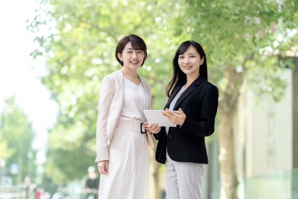 Two women smiling in business district stock photo