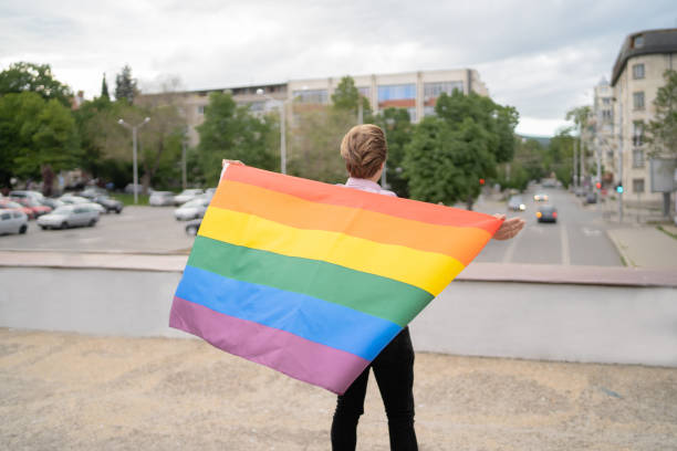 istock A man standing waving LGBT flag 1449827892