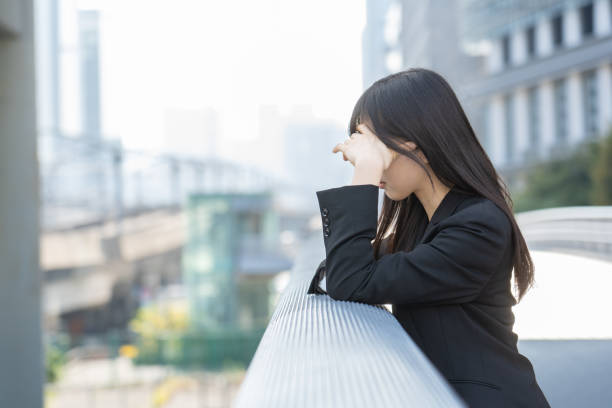Japanese woman worried about work stock photo