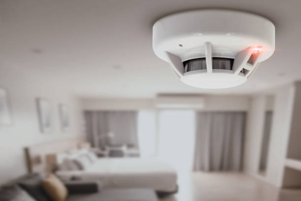 smoke detector fire alarm detector home safety device setup at home hotel room ceiling stock photo