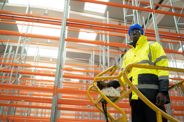 istock Moving stock driver in a warehouse a cherry picker 1449828645