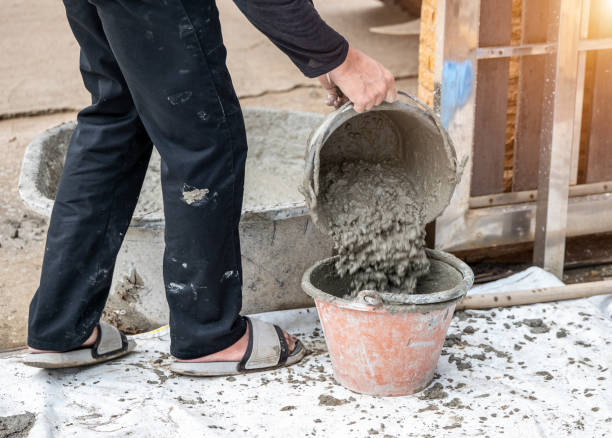istock pouring cement in bucket 1449831331