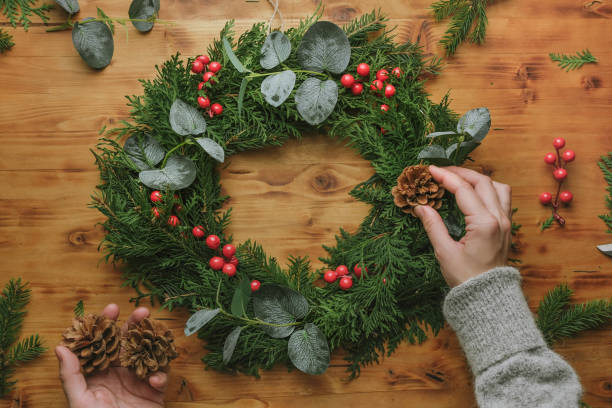 istock Hands making Christmas wreath for winter home decor. 1449836432