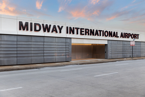 Chicago, IL, USA - November 9, 2020: The exterior of the Midway International Airport sign at the departures entrance during sunset.