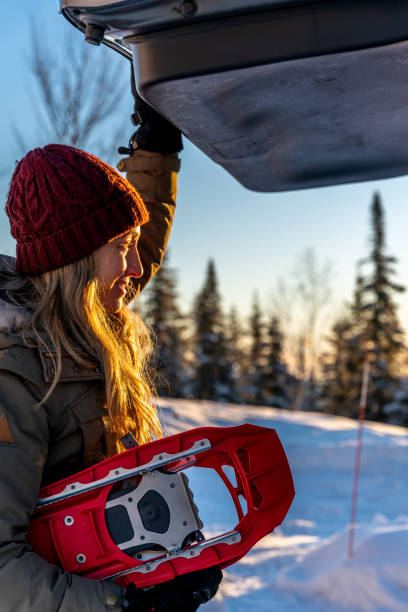 istock A woman getting ready to go snowshoeing. 1449836794