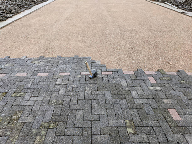 istock Top view of a construction site with a half-paved plot of land, paving stones, sand and a rubber mallet 1449837987