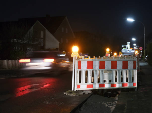 istock Construction site or excavation pit at night secured with barges and lamps 1449838004