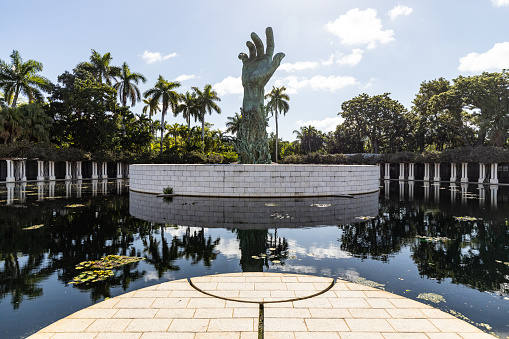 Miami Beach, FL, USA - October 14, 2019: The Holocaust Memorial in Miami Beach features a reflection pool with a hand reaching up and bodies climbing,  a memorial wall, and memorial bridge.