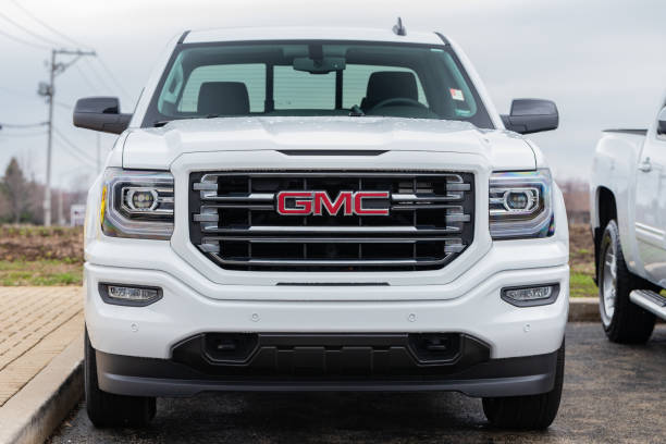 JOLIET, IL, USA - APRIL 9, 2019: The front end of a white 2018 GMC Sierra 1500 SLT 4WD., which has a towing capacity of 6,200 lbs.