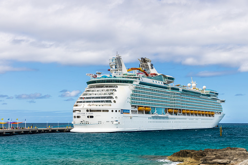 Nassau, Bahamas - October 12, 2019: A Royal Caribbean Navigator of the Seas cruise ship while docked at the CocoCay port where people can enjoy the private beach, food, drinks, and activities.