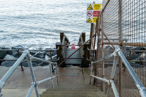 No swimming signs can be seen next to a boundary fence.