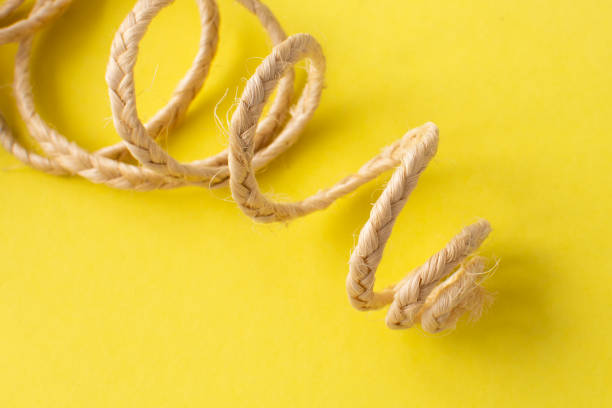 istock jute decorative ribbon on a yellow background. Decorative element 1449844412