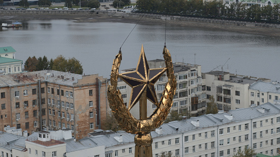 Serbia, Belgrade - May 20, 2022: flying around the star, symbol of USSR. Stock footage. City hall spire and the city center on the background