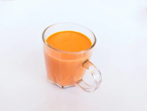 Cup of a milk tea creamy milktea caj (chai) or chaay milk shaicup a famous beverage of South Asia India Pakistan closeup image stock photo