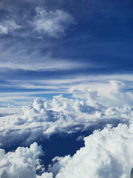 istock Peaceful blue sky background with clouds - vertical shot, perfect for wallpapers 1449856095