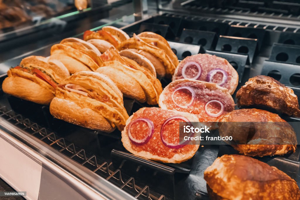 Traditional in german cuisine - mett sandwich with minced meat and onions for sale on a shelf of supermarket or fastfood cafe Bakery Stock Photo