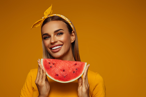 Portrait of girl holding slice of watermelon