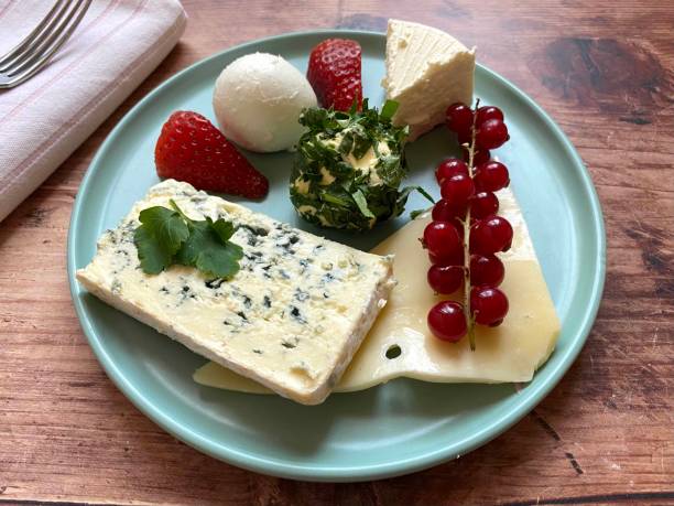 istock Different types of cheese, mozzarella, hard cheese, soft cheese, blue cheese, brie, emmental, with butter in parsley, strawberries and currants. 1449858737