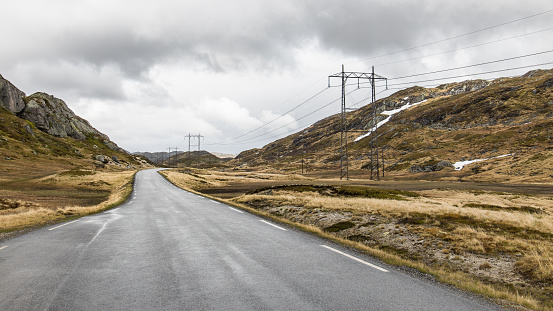 Mountain pass road and electricity power line through the highlands of Norway