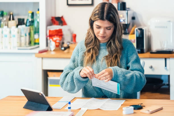 istock Young woman self-testing for COVID-19 at home 1449863325