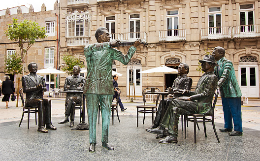 Pontevedra , Spain- July 12, 2011: Town square with Café Moderno statue, scultoric group reminding of cultural meetings, César Lombera sculptor.  Pontevedra city, Galicia, Spain.