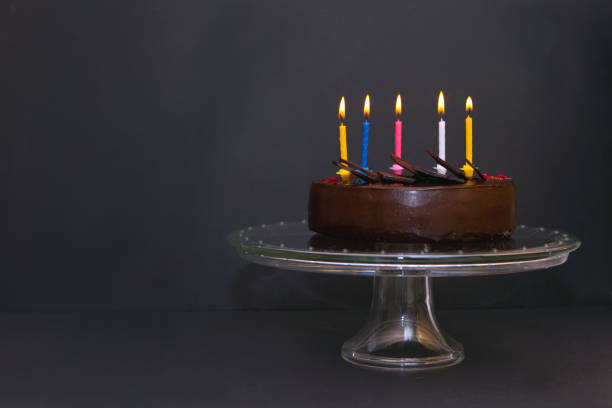 istock chocolate cake with five colorful candeles. Birthday cake with candel light 1449866599