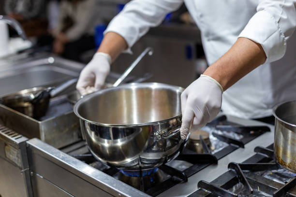 istock A cook stirring pots in the kitchen. Big pots in the kitchen 1449869201