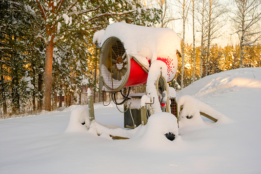 A snow gun that sprays artificial ice crystals. Snow making machine. For the pleasure of skiers.