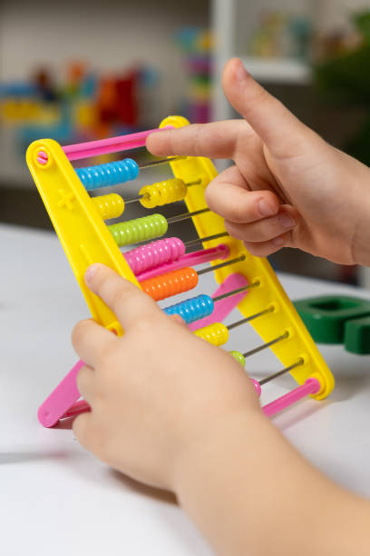 istock A small child learns to count on abacus, mathematics, arithmetic for children. 1449871699
