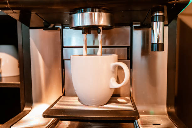 istock Coffee is poured into a cup in a cafe shop. Macchiato and coffee machine concept 1449874731