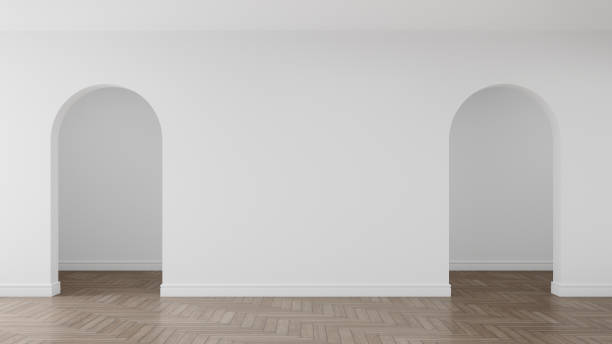 istock Empty white arch wall with white skirting board on wooden floor. 1449876101