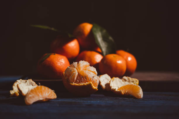 istock Close up on mandarins on wooden table. 1449883979