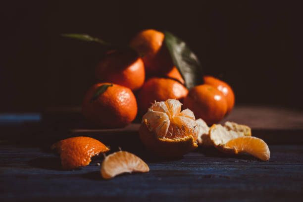 istock Close up on mandarins on wooden table. 1449883980