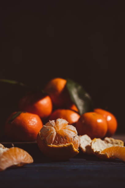 istock Close up on mandarins on wooden table. 1449883988