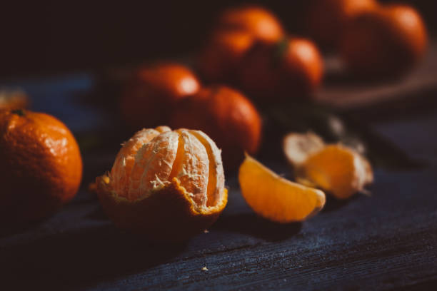 istock Close up on mandarins on rustic wooden table. 1449884008