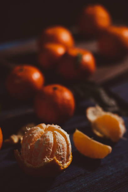 istock Close up on mandarins on rustic wooden table. 1449884009