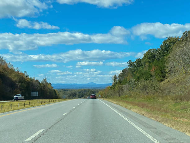 Open road in North Carolina mountains showing beginning of Autumn colors.