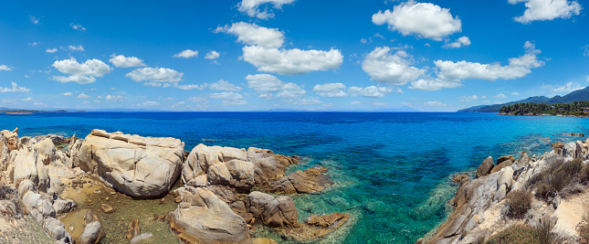 Aegean sea coast panorama and Karidi or Karydi beach (Chalkidiki, Greece). People are unrecognizable.
