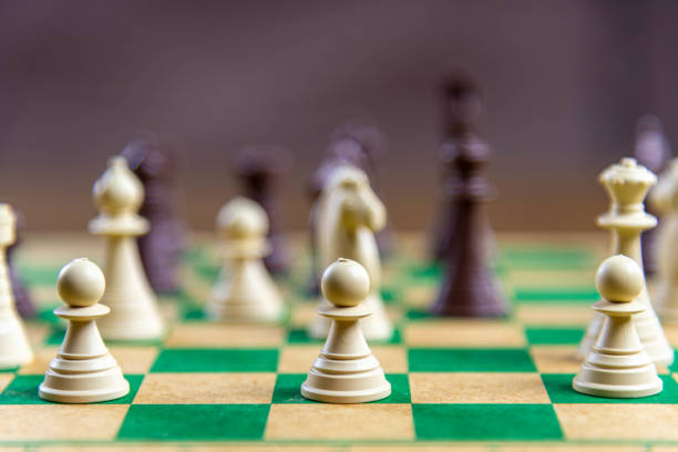 istock Chess game pieces on the green board 1449892752