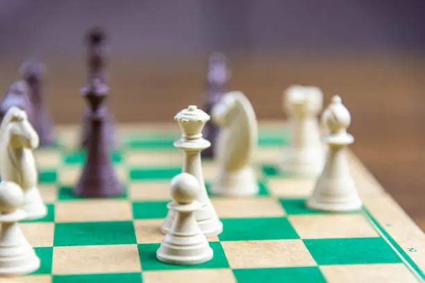 Photo of Chess game pieces on the green board