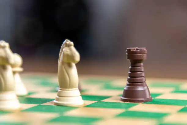 Photo of Chess game pieces on the green board