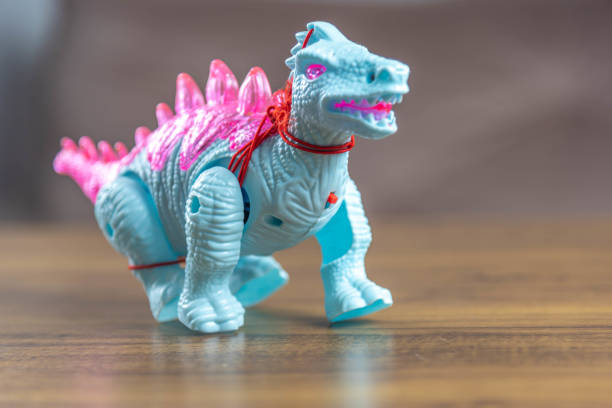 istock Toy dinosaurs on wooden surface 1449894743