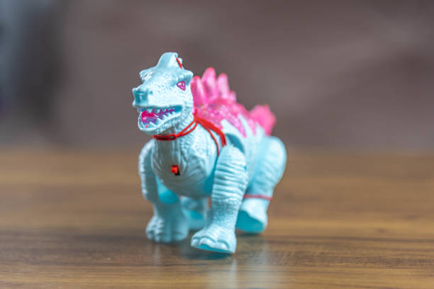 istock Toy dinosaurs on wooden surface 1449894749