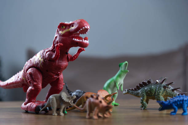 istock Toy dinosaurs on wooden surface 1449894796