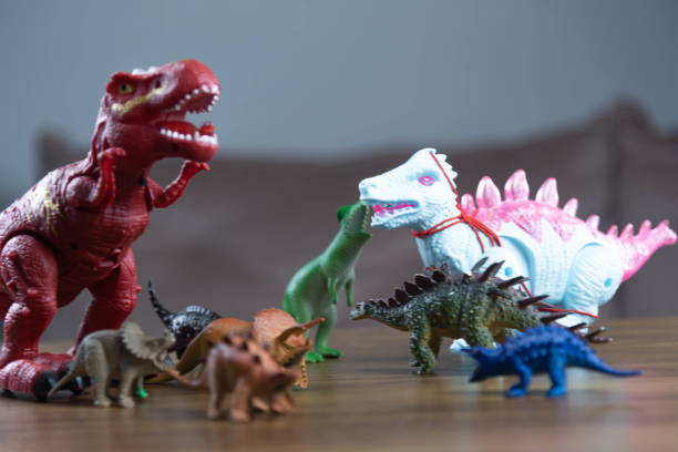 istock Toy dinosaurs on wooden surface 1449894798