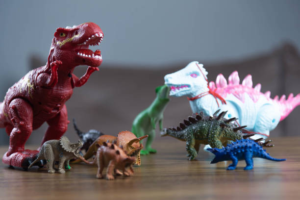istock Toy dinosaurs on wooden surface 1449894813